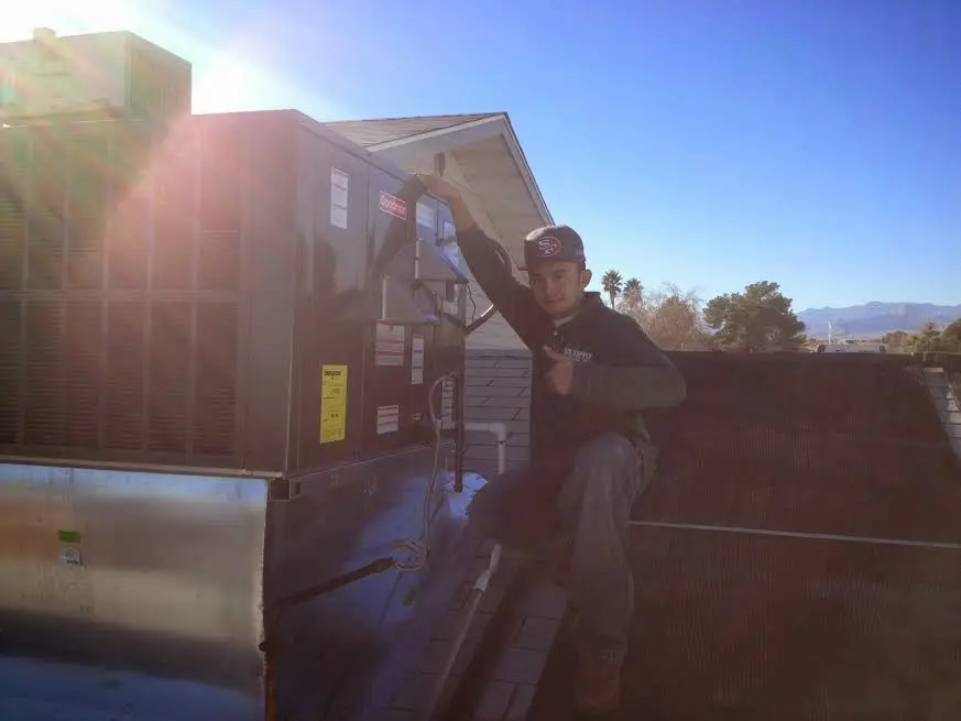 HVAC technician performing Boiler Repair on a rooftop unit in Fern Park
